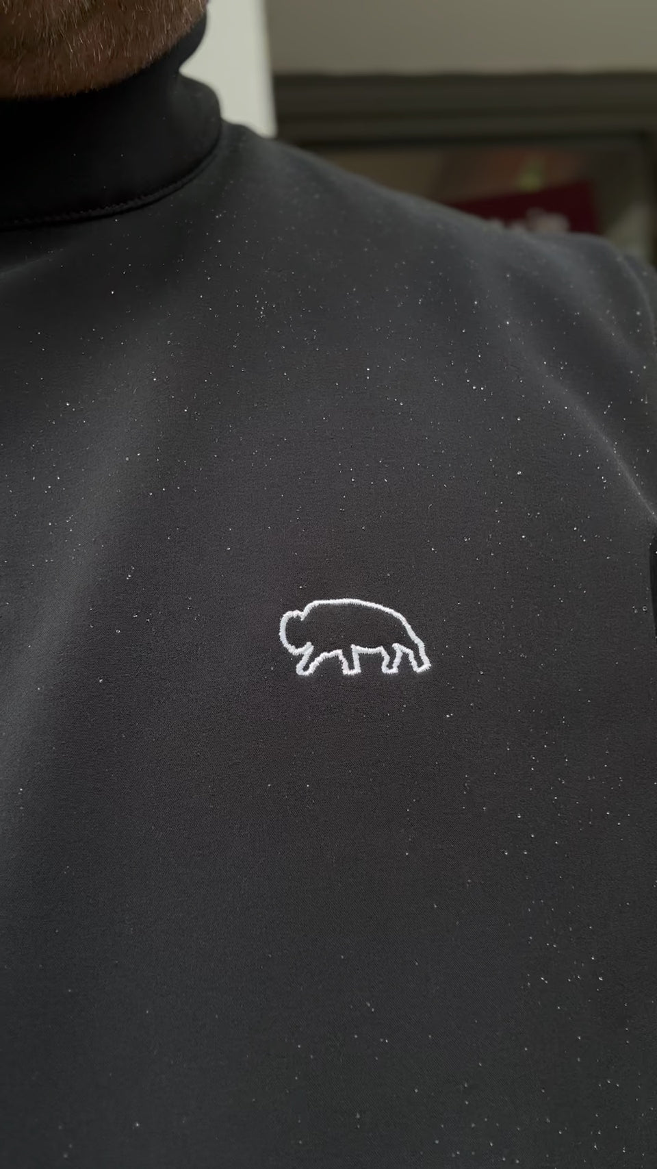 Black Breitung Jacket with a white bison ouline embroidered logo on a blurred background