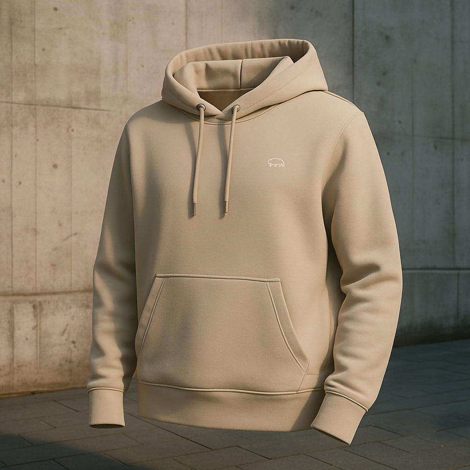 Beige Breitung hoodie with a small bison logo on a concrete wall background